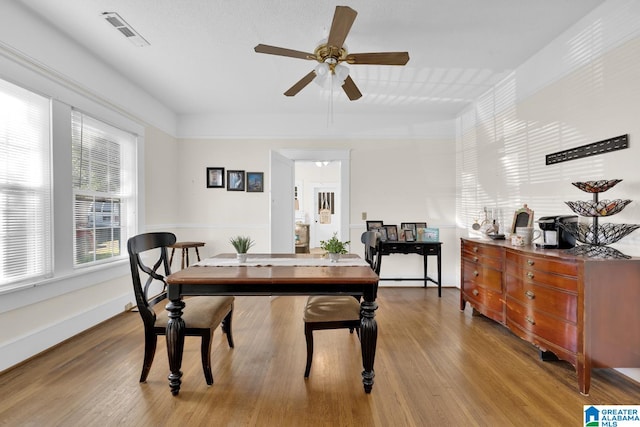 dining room with light hardwood / wood-style flooring and ceiling fan