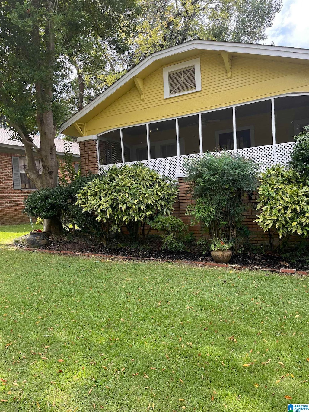 view of side of property with a yard