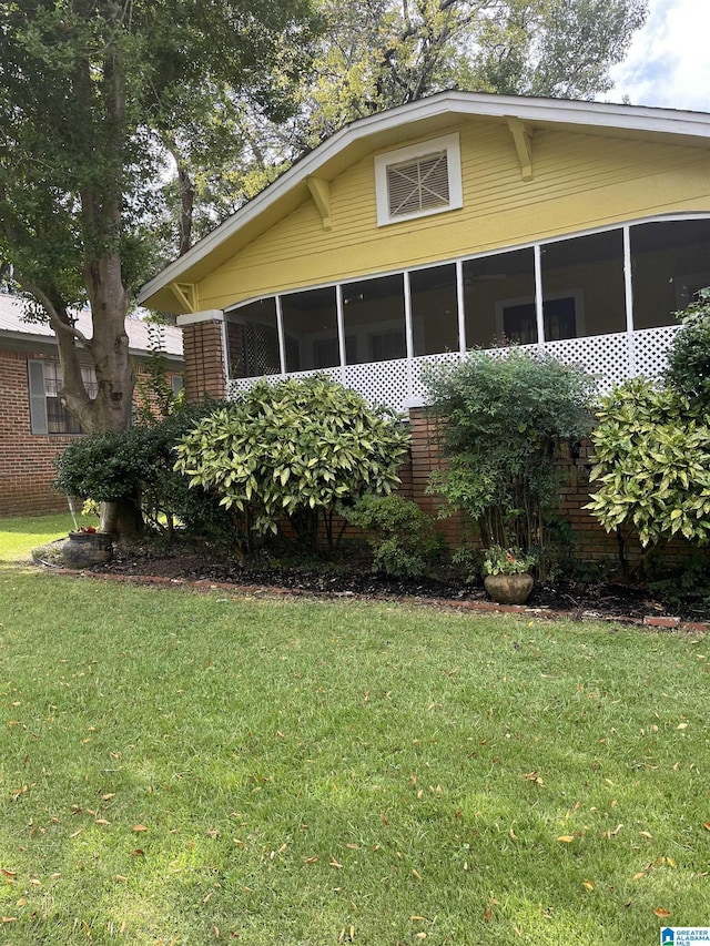 1244 15th St, Birmingham, AL 35211 - view of front facade featuring a sunroom, a front lawn, and brick siding