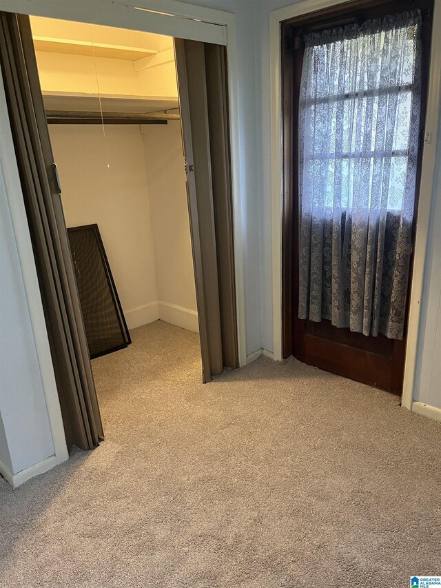 1244 15th St, Birmingham, AL 35211 - unfurnished bedroom featuring light colored carpet, attic access, baseboards, and a closet