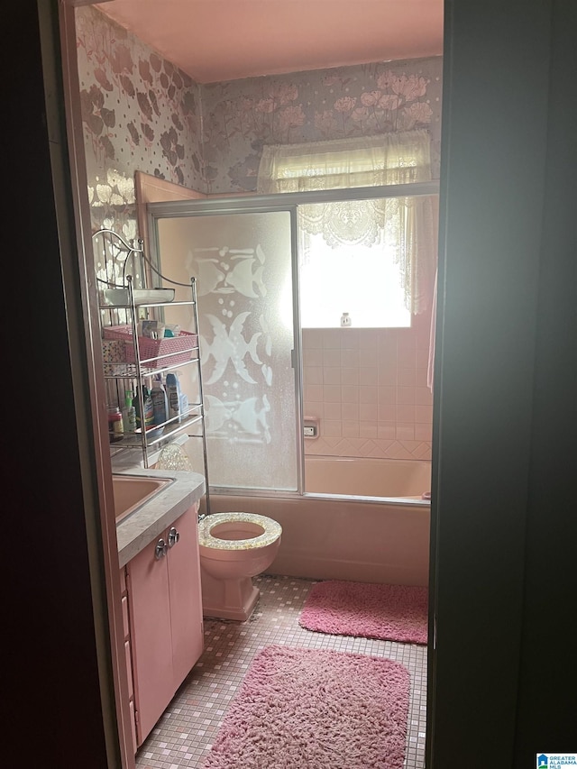 1244 15th St, Birmingham, AL 35211 - full bath with vanity, toilet, and shower / bath combination with glass door