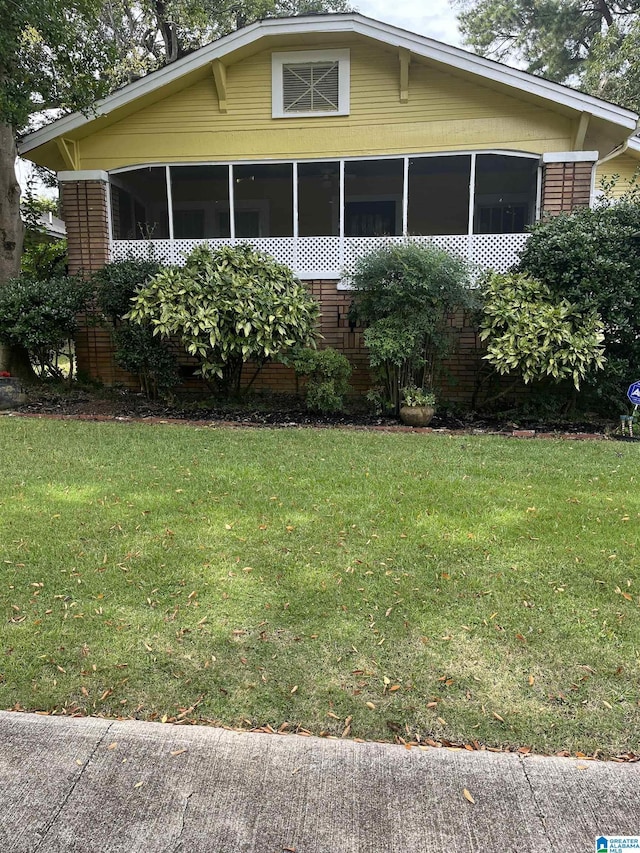 1244 15th St, Birmingham, AL 35211 - view of front of home featuring a sunroom, a front lawn, and brick siding