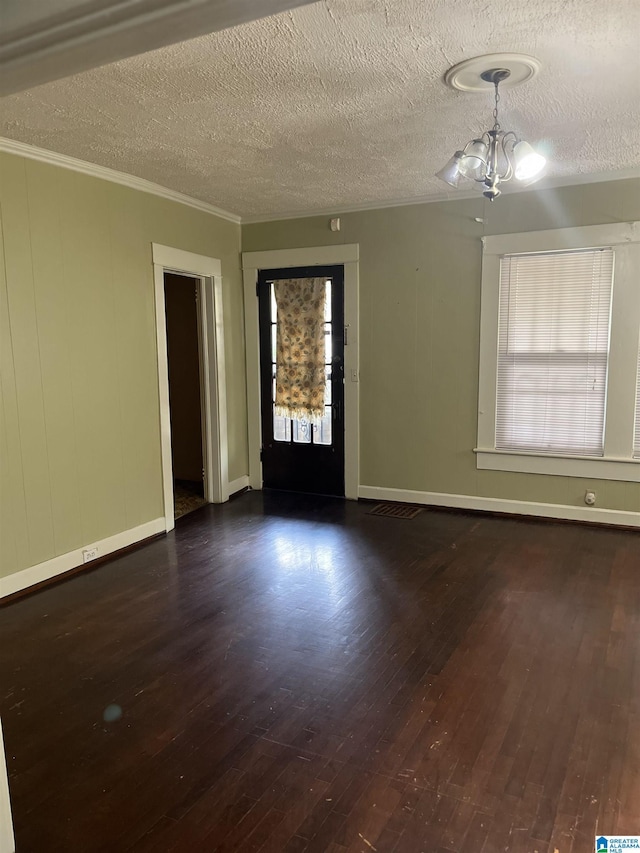 1244 15th St, Birmingham, AL 35211 - empty room with hardwood / wood-style flooring, a chandelier, a textured ceiling, baseboards, and crown molding