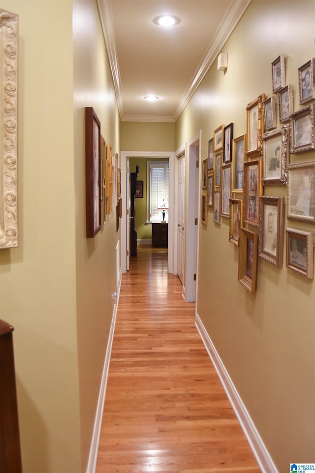 corridor featuring ornamental molding and light wood-type flooring