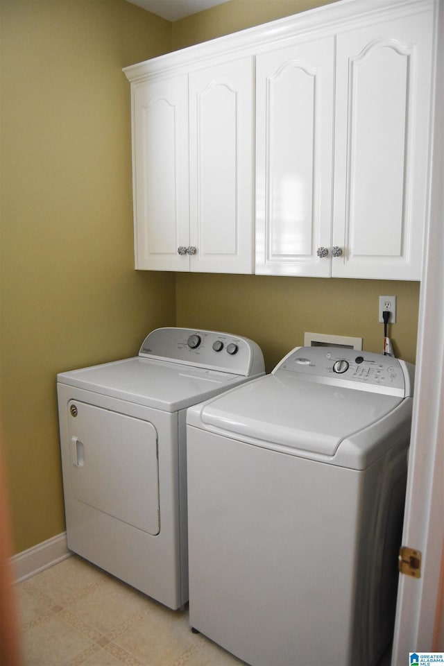 laundry area featuring cabinets and separate washer and dryer