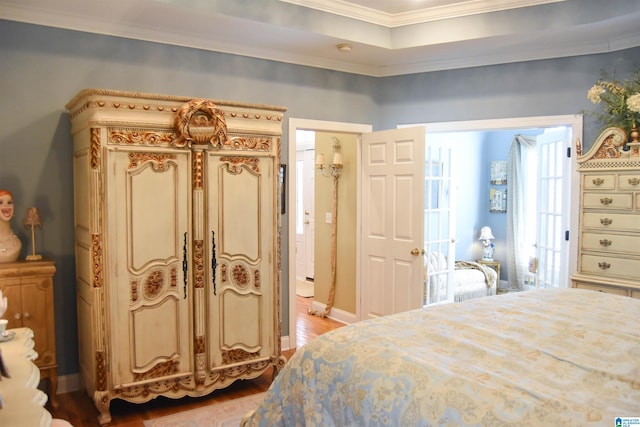 bedroom featuring ornamental molding and light hardwood / wood-style floors