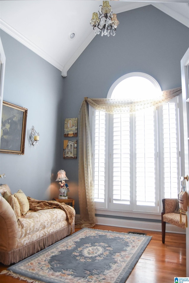 living area featuring ornamental molding, wood-type flooring, and vaulted ceiling