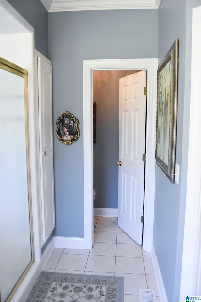 bathroom with crown molding and tile patterned floors