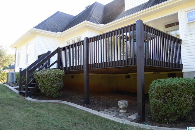 view of home's exterior featuring central air condition unit, a deck, and a yard