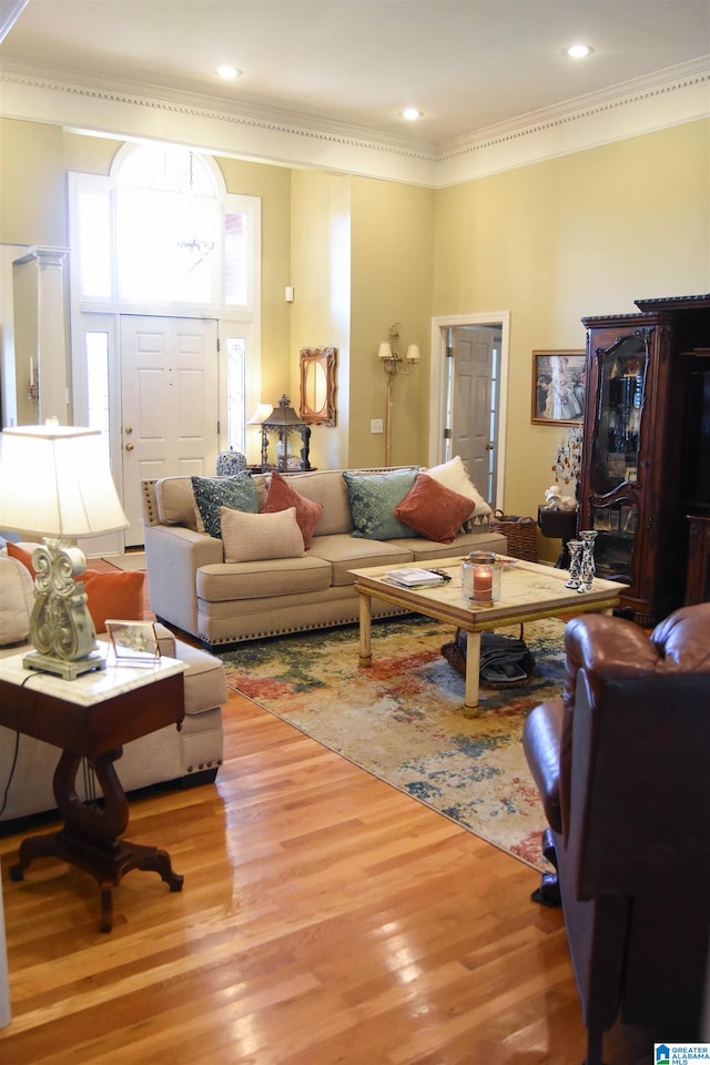 living room featuring hardwood / wood-style flooring and ornamental molding