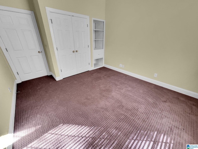 unfurnished bedroom featuring a closet and dark colored carpet