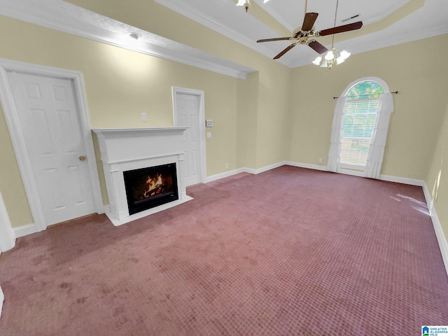 unfurnished living room featuring ornamental molding, carpet, and a raised ceiling