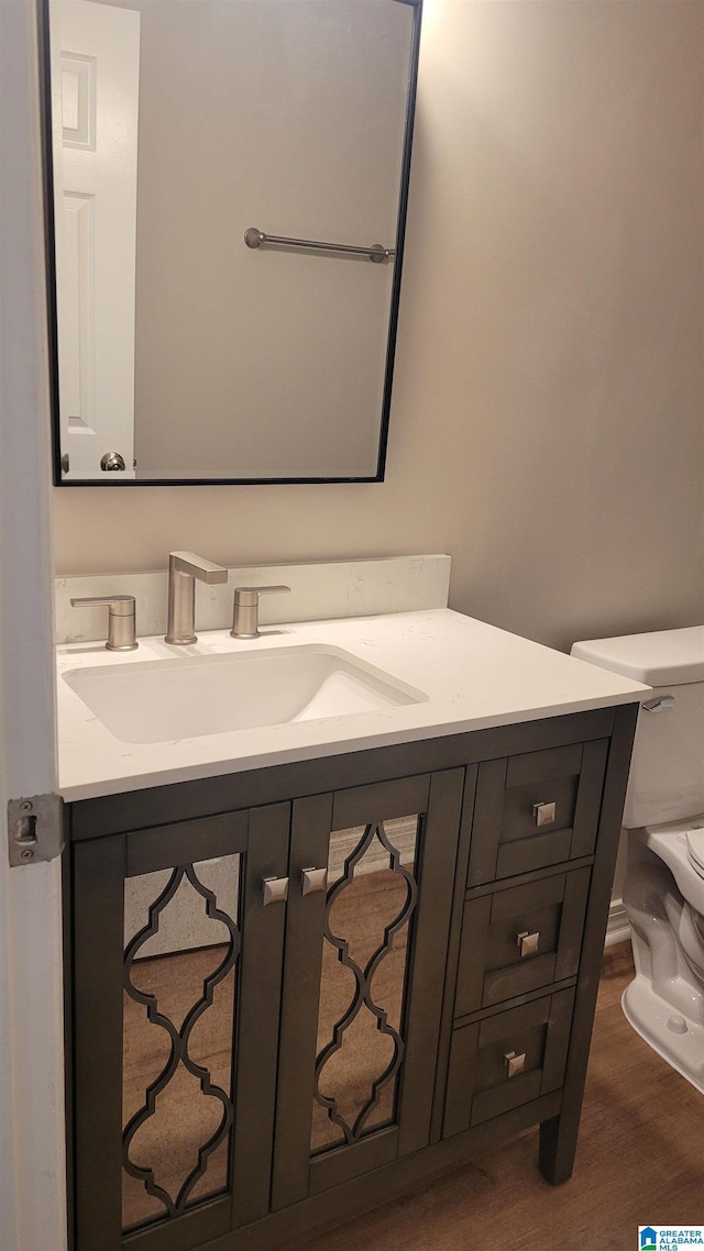 211 Morning Sun Dr Unit 211, Birmingham, AL 35242 - half bathroom featuring toilet, vanity, and wood finished floors