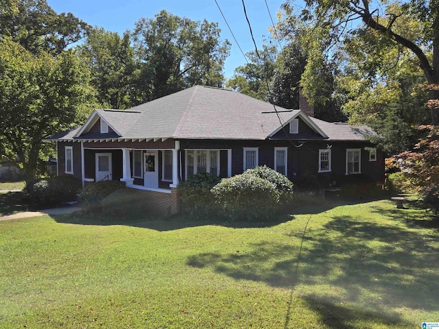 view of front of home with a front yard and a chimney