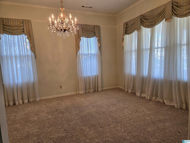 carpeted spare room with a chandelier, ornamental molding, and baseboards