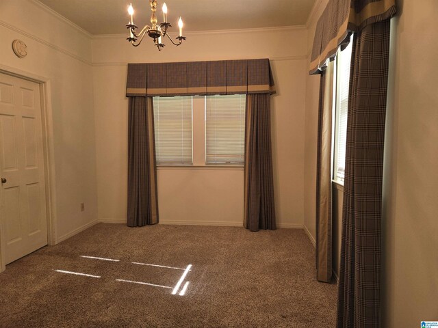 unfurnished bedroom with a chandelier, ornamental molding, carpet, and baseboards