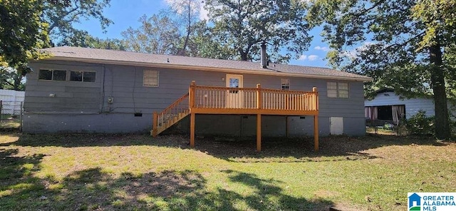 rear view of house with a deck and a lawn