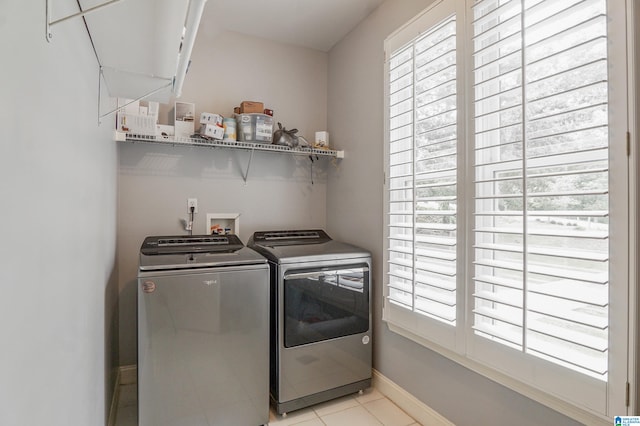 laundry room featuring light tile patterned floors and washing machine and clothes dryer