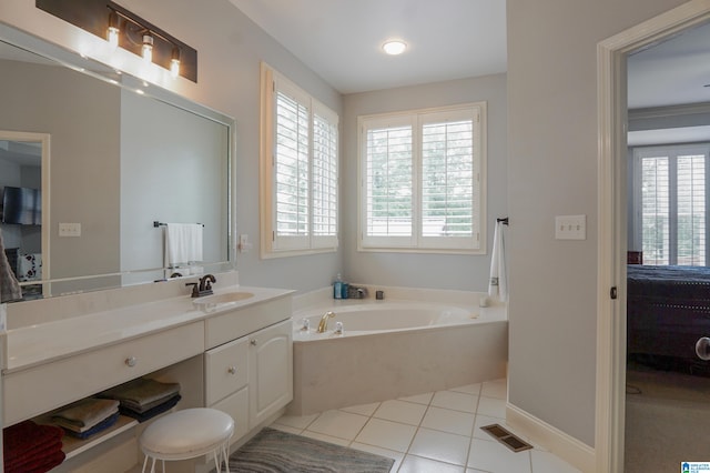 bathroom featuring vanity, ornamental molding, a bathtub, and tile patterned flooring