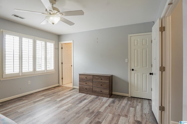 unfurnished bedroom with ceiling fan and light wood-type flooring