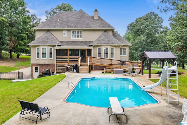 view of swimming pool featuring a water slide, a patio, a yard, a gazebo, and a diving board