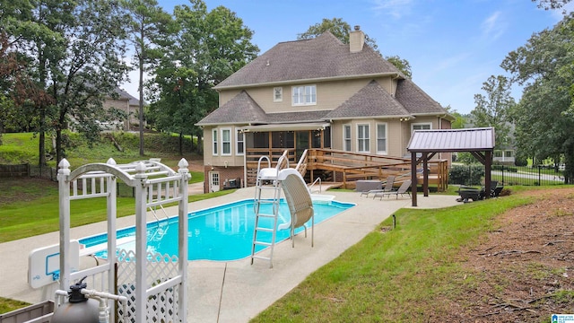 view of pool with a hot tub, a water slide, a yard, and a patio