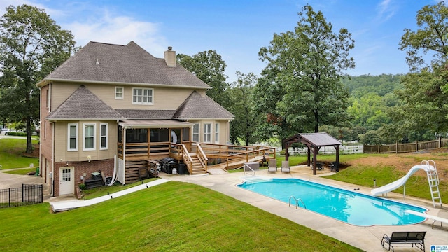 rear view of house with a gazebo, a pool side deck, a yard, and a patio area