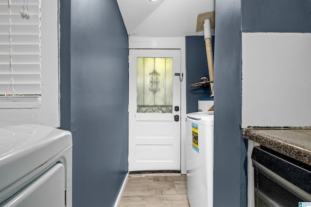 laundry room with washer / dryer and light wood-type flooring