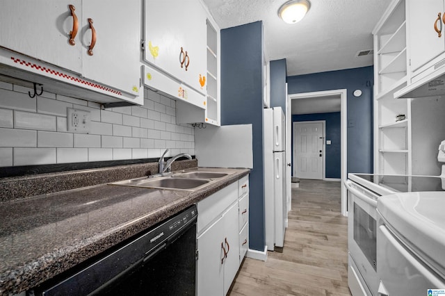 kitchen with white appliances, sink, backsplash, white cabinetry, and light hardwood / wood-style floors