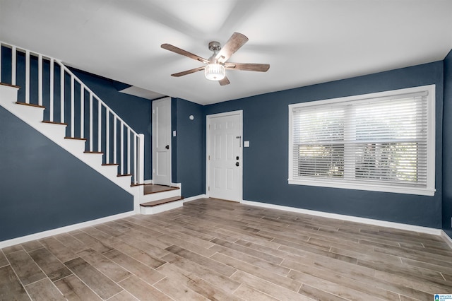 foyer with hardwood / wood-style flooring and ceiling fan