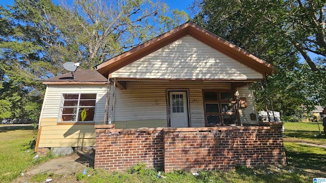 bungalow-style house with a front yard and a porch