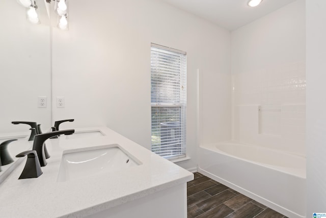 bathroom with vanity, hardwood / wood-style floors, and shower / bathing tub combination