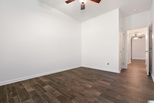 unfurnished room with dark wood-type flooring and ceiling fan