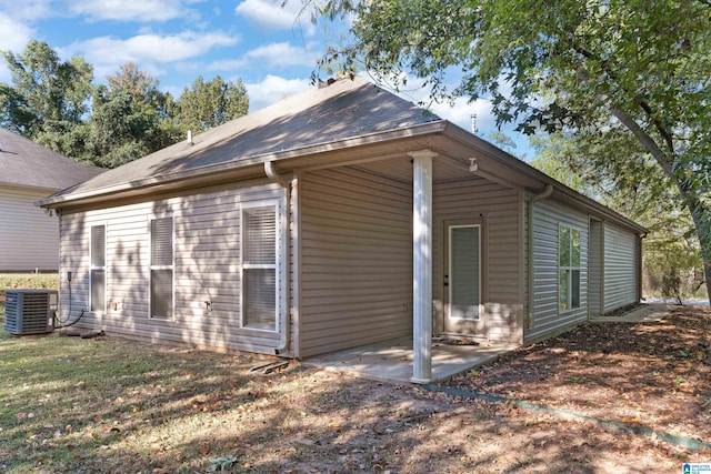 view of side of property with a patio area and central AC unit