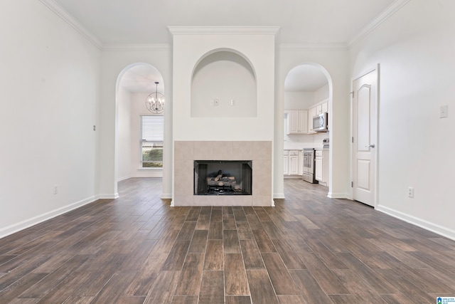 unfurnished living room featuring ornamental molding, dark wood-type flooring, and a fireplace