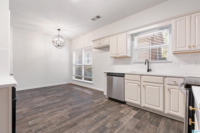 kitchen featuring sink, dishwasher, decorative light fixtures, stove, and dark hardwood / wood-style floors