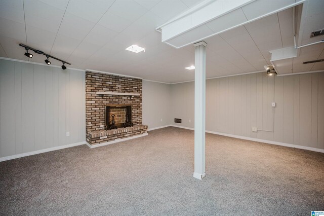 520 Hickory St, Birmingham, AL 35206 - finished below grade area with carpet floors, rail lighting, a brick fireplace, and ornamental molding