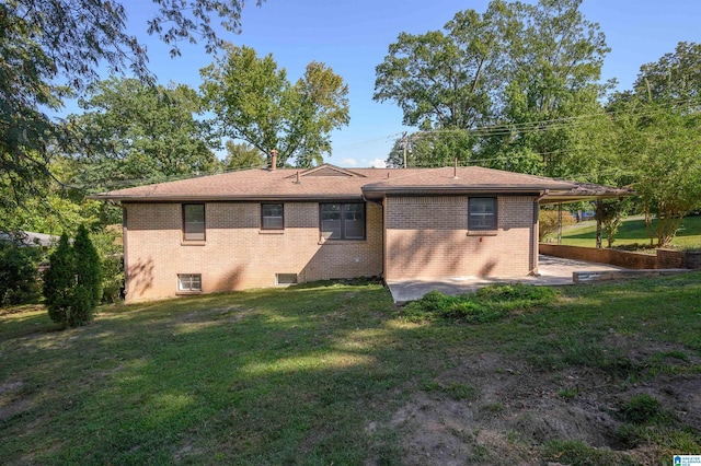 back of house featuring a patio and a lawn