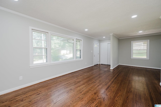 unfurnished room with crown molding, a textured ceiling, and dark hardwood / wood-style floors