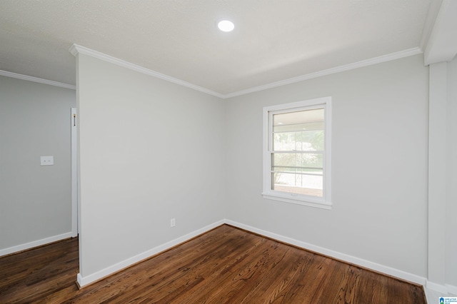 empty room featuring ornamental molding and dark hardwood / wood-style flooring