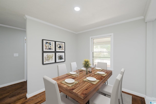 dining area featuring dark wood-type flooring and crown molding