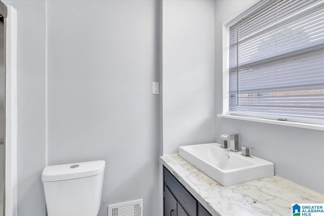 bathroom with toilet and vanity