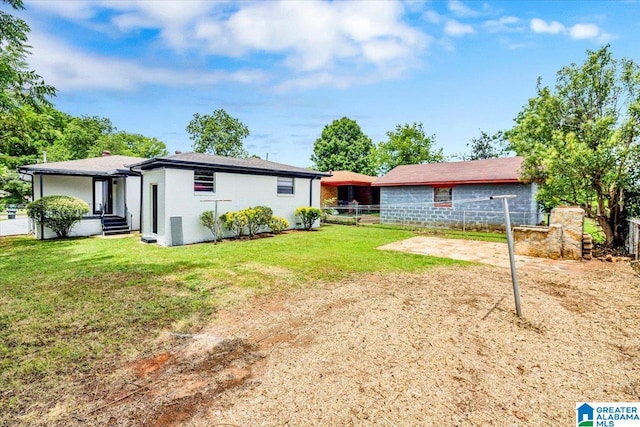 rear view of property featuring a lawn