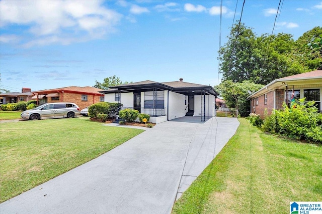 view of front of house with a front lawn and a carport