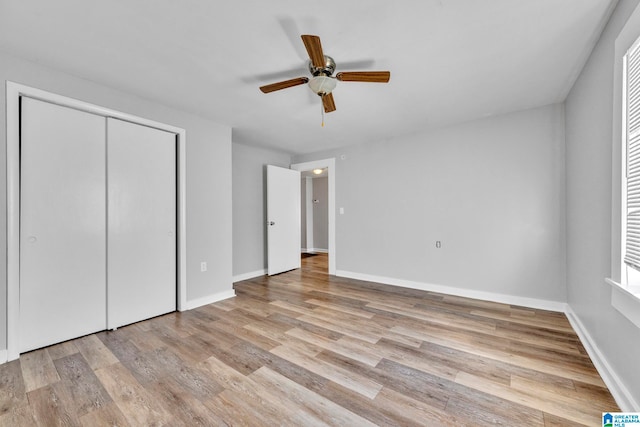 unfurnished bedroom featuring a closet, ceiling fan, and light hardwood / wood-style flooring