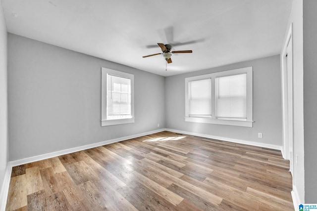 unfurnished room with light wood-type flooring and ceiling fan