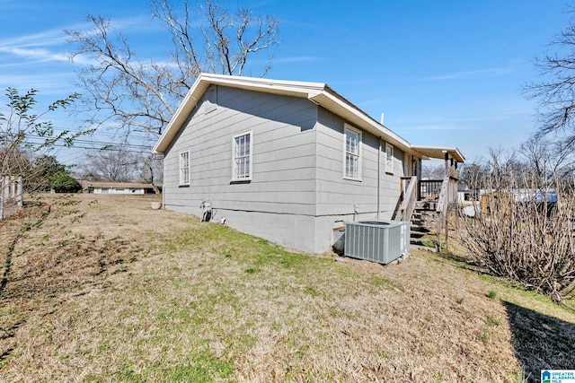 view of home's exterior featuring a yard and central AC unit