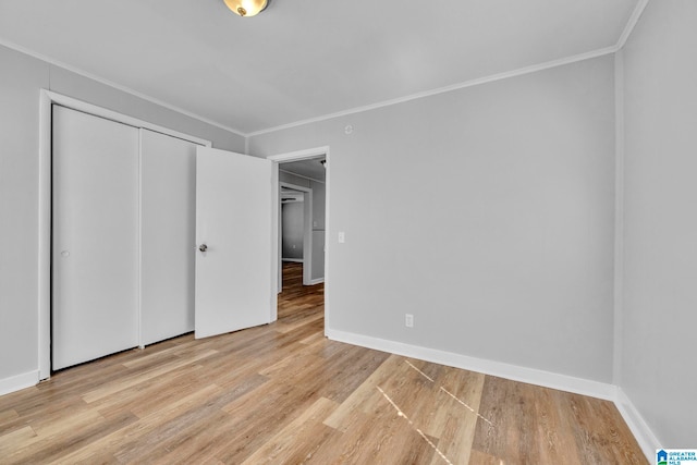 unfurnished bedroom featuring a closet, light hardwood / wood-style floors, and ornamental molding