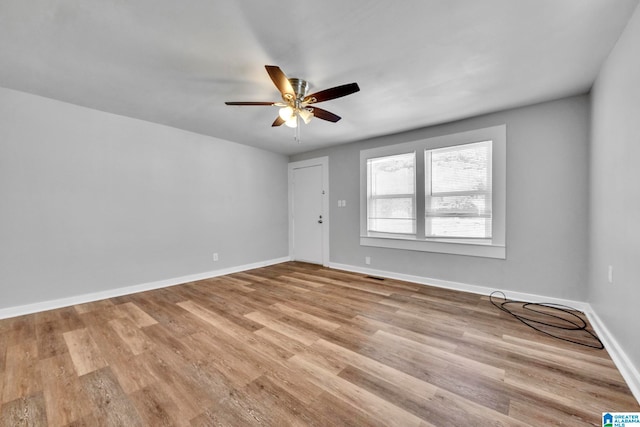 empty room with light wood-type flooring and ceiling fan