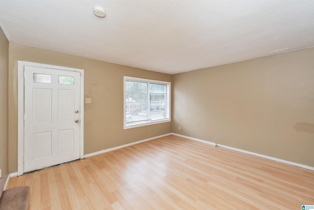 entryway featuring light hardwood / wood-style floors and a textured ceiling